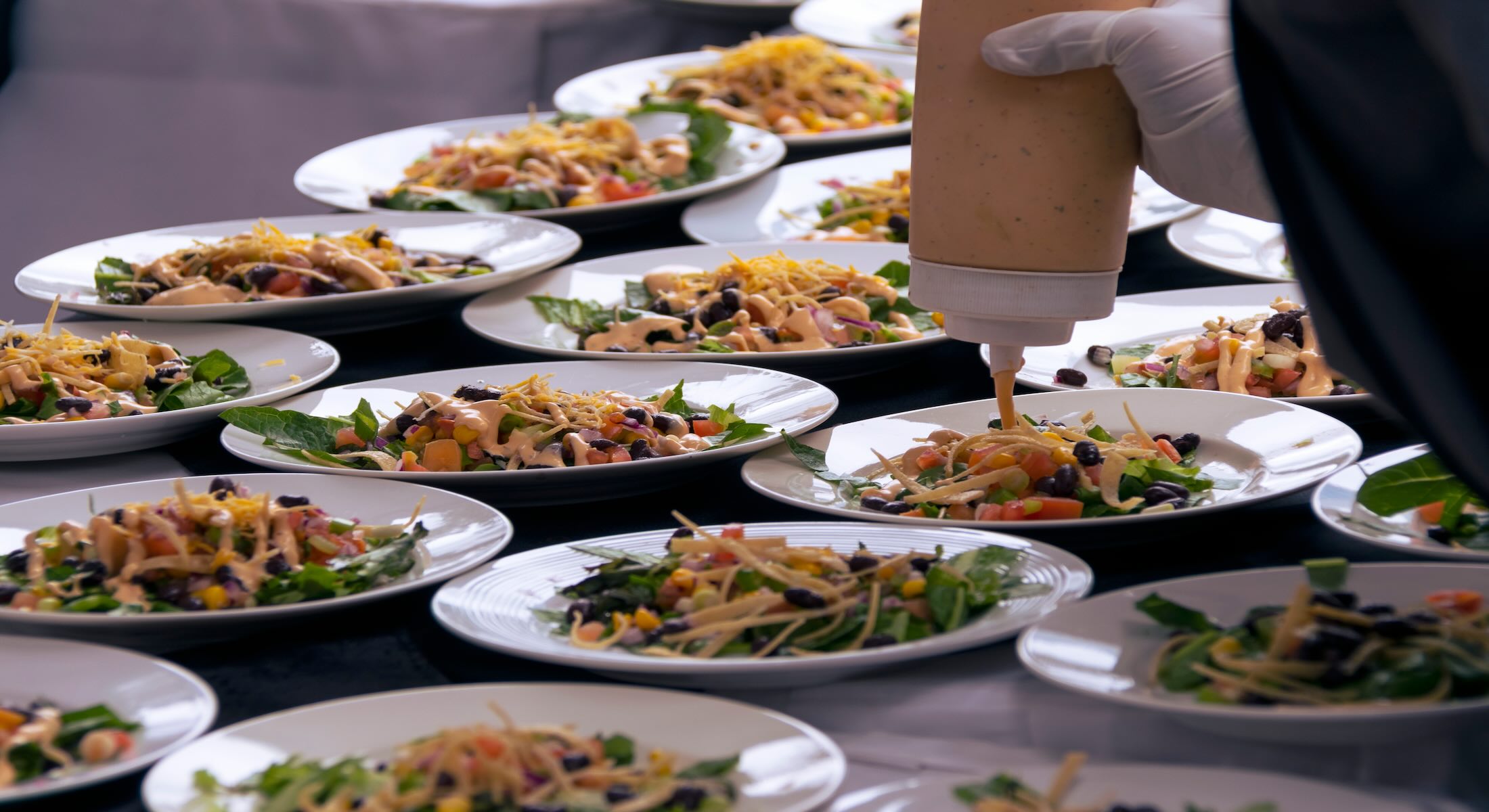 Commercial kitchen staff plating meals at scale to support operational consistency in foodservice