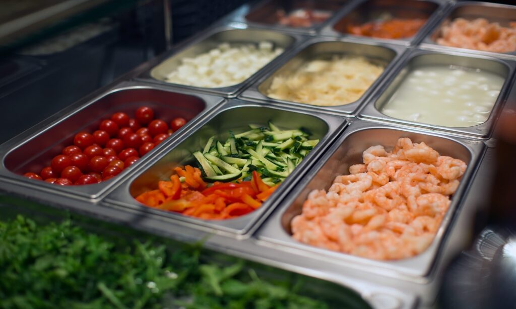 Organized restaurant food prep station demonstrating standardized workflow and food safety processes for operational efficiency